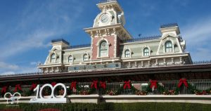 Magic Kingdom Entrance at Christmastime during the 100th celebration. This iconic photo spot also gets decorated at Christmas.